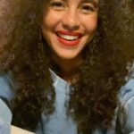 Parisa Fitz-Henley Instagram - Today’s the day! Some history of two orgs I appreciate so much on this #GivingTuesday — @themonafoundation and @tahirihjustice. Please see their pages for info on how to contribute. TW: Mention of violence. Both these orgs were inspired by women who were killed for their beliefs and actions. Tahirih was a 19th century Persian poet, renowned for her deep religious and spiritual insights and revolutionary approaches (daring to speak of theological concerns the way men did and publicly removing her veil). At 38, held captive for being a Bahá’i, she was strangled with her veil after uttering the words: “You can kill me as soon as you like, but you will never stop the emancipation of women.” In 1983 Mona Mahmudnizhad was just 17 when she was was tortured and sentenced to death by hanging in Iran for “misleading children and youth” as a teacher of Bahá’i children’s classes. Though the US formally requested clemency, Mona and nine other Bahá’i women were executed. As a Bahá’i myself, I grew up with the stories of these women (the Bahá’í Faith originated in what was known as Persia, now known as Iran). It’s been an honor to support the work done in their names by organizations who, while inspired by Bahá’i women and ideals, are run by and in support of people of all Faiths and beliefs, and who focus on making sure that women and girls are centered. Though doing it in different ways, both these organizations are breaking cycles and paving new paths with and for so many people, in the US and all around the world. Please consider getting to know these orgs today and if you’re able and feel moved to contribute, truly any amount would be appreciated. Many thanks. 🙏 Video: Close up of me, brown skin, dark brown eyes and longish curly brown hair with a few silver strands. I’m wearing red lipstick and a sky blue and white abstract pattern sweatshirt (hand-dyed with indigo and high vibes — shout-out @laylidyeshard) and extra large hoop earrings. I’m leaning on a white mantle.
