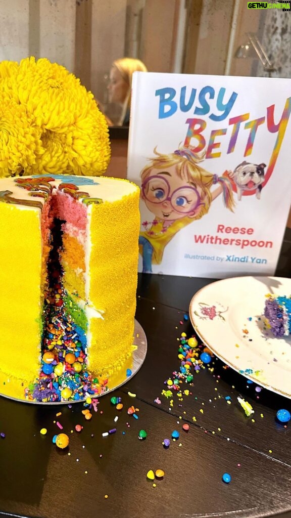 Reese Witherspoon Instagram - This Busy Betty is ready for the weekend, y’all 🫠😜 Pick up a copy wherever books are sold. Also this rainbow cake from @flourshop is 💯 🌟