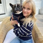 Reese Witherspoon Instagram - Matching sweaters with my pup?!?! 😍😍😍 The @draperjames x @thefoggydog collection is everything this dog lady has ever dreamed of. Shop now!!!