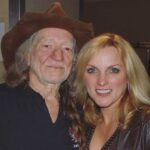Rhonda Vincent Instagram - 14 years ago today - Friday, November 6, 2009 - The day I met #WillieNelson @willienelsonofficial when we opened a show for him @theryman With great anticipation, we took the stage. The house lights were up and never dimmed as we started the set with our bluegrass “Song of the Year” - Kentucky Borderline. People were milling about, barely applauding, and barely listening. Since we don’t use a set list, it became a challenge to find the right song that the audience might react to. We played another song of the year - Is The Grass Any Bluer on the Other Side. Still no response, so I decided on one of the fastest songs we do, sang by Mickey Harris - Lost All My Money But A Two Dollar Bill”. That was the magic song that turned things around. They immediately started listening and the response was amazing. They were intently listening, so now the new challenge would be how they would react to an accapella gospel song “Fishers of Men”. It worked!! Standing ovation at the Ryman. Sometimes you just gotta find the right song. I was honored to record with Willie on two of my albums. His line on the Christmas project “Eleven pipers piping” on the Twelve Days of Christmas is the BEST! He also sang a duet with me on the song “Only Me”, singing and playing guitar!! Willie — you are amazing and I’m honored to have these opportunities. Thank you!! Ryman Auditorium