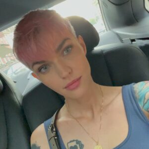 Ruby Rose Instagram - Peekaboo NYC. 🥰😍 I love the fall. X Thank you @fendi @silviaventurinifendi @mrkimjones #fendipeekaboo #ad

Image description 

Slide one:
I am standing in a NY street, next to a potted plant and a stairway. I’m wearing a new bag and my hair is pink and my heart is full.

Slide two: 
Someone ( a friend of mines son ) asked me to wear this dress, I’ve never worn a wrap dress and put it on back the front originally.. I corrected it for this photo. I have sunglasses on, but am inside, don’t judge me. 

Slide three: I am sitting in a taxi cab, petting my new bag because I’m a little awkward.