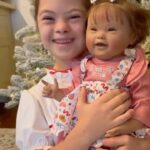 Sofia Sanchez Instagram - Christmas came with a little “extra” magic this year! The most beautiful baby doll with a little something extra. Her name is GiGi and she’s PRECIOUS! Thank you @paradisegalleries for creating a baby doll that captures the rare beauty of Down syndrome. We will cherish her! #nevertooold #underneaththetree #downsyndromeawareness