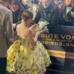 Sofia Sanchez Instagram - World Premiere in Berlin for @thehungergames The Ballad of Songbirds & Snakes 🕊️🐍 I had the time of my life meeting fans, signing autographs and watching the movie for the very first time! It is the most amazing film and I’m so proud! My dress is an homage to the working title of the film “Butterfly” as well as a nod to the butterfly symbol for Down syndrome awareness and my debut as an actress on the big screen. The colors yellow and blue are the colors of DS Awareness and my home country Ukraine. Truly a work of art by the amazing #houseofpetunia It was a night I will never forget! #corememory Custom Dress & Styling: @dolorispetunia 🦋 Hair & Makeup: @thesanchezsix 💫 Upper West Berlin
