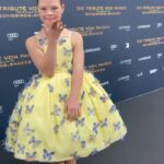 Sofia Sanchez Instagram - World Premiere in Berlin for @thehungergames The Ballad of Songbirds & Snakes 🕊️🐍 I had the time of my life meeting fans, signing autographs and watching the movie for the very first time! It is the most amazing film and I’m so proud! My dress is an homage to the working title of the film “Butterfly” as well as a nod to the butterfly symbol for Down syndrome awareness and my debut as an actress on the big screen. The colors yellow and blue are the colors of DS Awareness and my home country Ukraine. Truly a work of art by the amazing #houseofpetunia It was a night I will never forget! #corememory Custom Dress & Styling: @dolorispetunia 🦋 Hair & Makeup: @thesanchezsix 💫 Upper West Berlin