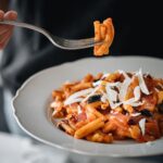 Stefano Faita Instagram – Qu’est-ce qui nous donne un bon boost avant un marathon?! Des glucides!
Je vous partage ma recette de recette préférée que je fais avant une course, en honneur du @marathonptittraindunord. Question de faire le plein d’énergie avant mon prochain 21km 🏃‍♂️

Recette Marathon P’tit Train du Nord

Ingrédients

• 80 ml (⅓ tasse) d’huile d’olive extra vierge Stefano (divisée)
• 2 aubergines ou courgettes de taille moyenne, coupées en cubes de ½ po
• Sel et poivre fraîchement moulu, au goût
• 1 oignon rouge de taille moyenne, haché
• 3 gousses d’ail, émincées
• 648 ml (1 pot) de sauce marinara Stefano
• Une pincée de flocons de piment , au goût
• 454 g (1 paquet) de pâtes courtes 
• 250 ml (1 tasse) de feuilles de basilic fraîches, déchirées
• Copeaux de ricotta salata (pour la finition)

Préparation

1. Dans une grande poêle, chauffer 1 c. à table de l’huile d’olive à feu moyen-élevé
2. Ajouter 1 c. à table d’huile d’olive supplémentaire et cuire un tiers des morceaux d’aubergine 5 à 7 minutes, ou jusqu’à ce qu’ils soient bien dorés de tous les côtés. Saler et poivrer au goût. Retirer de la poêle et réserver. Répéter les étapes deux autres fois avec les tiers restants de morceaux d’aubergine.
3. Réduire le feu à moyen, et toujours dans la même poêle, ajouter les 2 c. à table d’huile d’olive restantes, l’oignon et l’ail. Cuire 3 à 5 minutes, ou jusqu’à ce que l’oignon soit tendre. Saler et poivrer au goût.
4. Incorporer la sauce marinara et les flocons de piment. Ajouter les morceaux d’aubergine cuits et bien mélanger. Laisser mijoter 10 minutes.
5. Entre-temps, amener une grande casserole d’eau salée à ébullition. Cuire les pâtes en suivant les directives inscrites sur l’emballage. Avant d’égoutter, réserver environ ½ tasse d’eau de cuisson.
6. Ajouter les pâtes cuites et le basilic à la sauce. Remuer soigneusement pour bien enrober les pâtes. Ajouter un peu d’eau de cuisson au besoin.
7. Dresser les pâtes dans une assiette de service et garnir de copeaux de ricotta salata. Servir immédiatement.

Bonne course!