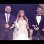 Tamer Hosny Instagram - لكل اللي بيسأل عن ايه وجه القرابه بيني و بين العروسه الجميله دي شايف اسأله كتير انا هحكيلكوا 😀هي اسمها هاله عمر عرفتها كانت بنت من الفانز صغيره و من المقاتلين و المدافعين عن تامر على الانترنت 😀💪و من كتر دفاعها عني لفتت نظري و مره رديت عليها شكرتها و لما سافرت اسكندريه في الوقت ده لقيت بنت صغيره اوي بتعيط و بتجري عليا فا وقفتلها و فكرتني بنفسها و فضلت تعيط 😢و تقولي احنا معاك و لازم تكمل عشان كنت بتحارب جداً في بداياتي فا اتصدمت ان اللي بتقول كده بنت صغيره كده و المجهود ده كله اللي عاملاه بنت صغيره عندها ١٤ سنه وقتها كانت السوشيال ميديا لسه بتطلع و كنا في شركتنا بندور على شركه كبيره تمسكلي السوشيال ميديا لحد ما قولتلهم انا مش عايز شركه كبيره انا عايز البنت الصغيره دي هي اللي تمسكها فضلوا يقنعوني ان كده مش صح ولازم اكتر حد خبره يمسكها وانا قولت لا لازم اكتر حد بيحبني هو اللي يمسكها و انا واثق ان طاقة الحب مفعولها اقوى من طاقة المحترف بلا حب فعرضت عليها تشتغل معايا و هي في السن ده مصدقتش طبعاً و من ساعتها و هي اللي ماسكه كل شغل الميديا الطفله الشاطره اللي كبرت دلوقتي قدامكم هاله عمر ،،، اما بقى عريسها العسل ده اسمه عمرو طلب اديها مني انا عشان والدها و والدتها توفاهم الله. في سنه واحده رحمهم الله ياريت نفتكرهم و نهديلهم ثواب الدعاء و الفاتحه .. و من اللحظه دي اتحولت هاله لبنتي الكبيره بجد اللي بتتجوز دلوقتي قدامي و بسلمها لعريسها بنفسي و بغني في فرحها ، معرفتش ارد على كلامك عني في الفرح يا هاله رديت دلوقتي هنا ربنا يكرمك و يسعدك مع جوزك الجميل المحترم اللي هيكون ضهرك و سندك و يكمل معاكي مشوار حياتك مع اولادكم الجُمال بإذن الله 🤲 @halllaomar @amrserag1 @ahmedyassinweddingplanner @tareksabry1 @menam_photography