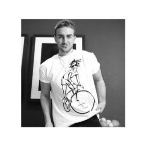 Tom Austen Instagram - Get on yer bike! 🚲 🚲🚲 Very proudly sporting and supporting @smartworkscharity for
This years International Women’s Day
@bettyjacksonlondon has designed a special T shirt for @smartworkscharity for their  #SpinForSmartWorks cycling challenge #PedalForAPurpose 
Friday 2 March – Thursday 8 March, 
Sign up and get this T shirt or just buy it coz it’s ace. 
Smart Works is an amazing charity that supports unemployed women with upcoming job interviews providing them with a complete outfit of high quality clothing (free and theirs to keep) and one-to-one interview coaching.  In 2017 they supported 3000 women with interview preparation, empowering them with the confidence they needed to succeed.  59% went on to get the job and start a new chapter in their lives.
Link in the bio. Check it oooot
Big love
👊🏽🖤 x