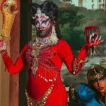 Vermelha Noir Instagram - 🩸 Chinnamasta 🩸 Es una diosa hindú que se representa desnuda auto-decapitada, normalmente en pie o sentada en una pareja divina copulando, sostiene su cabeza decapitada en una mano y una cimitarra en la otra. Tres chorros de sangre surgen de su cuello y son bebidos por la cabeza decapitada y dos asistentes. Es la diosa de las contradicciones. Simboliza ambos aspectos de Devi: la que da y la que quita la vida. Es considerada tanto un símbolo de autocontrol sexual como una personificación de la energía sexual, dependiendo de la interpretación. Representa la muerte, la temporalidad y la destrucción así como la vida, la inmortalidad y la recreación. Para este trabajo en colaboración con @dankografia y @jesusteayude cuento con la presencia de ellos mismos como la pareja copulando y a mi hijo @bendeck_bendeck y @lvbnagaia cómo las entidades a los lados de la diosa. . Fotografía y dirección C @dankografia @jesusteayude Dress & heels: La presi y Makeup, headpiece & styling: Vermelha Noir . 💄 PRODUCTOS 💄 ⚪Base : Labial Rojo MAC Cruella 👁️ Ojos y contour : @jeffreestarcosmetics ⚫Delineador y cejas @guerlain 🖤 Labios @naturalgirl ⬛ Enmarcado @bodypaintbykj . #fashion #drag #gay#art #makeup #lgbt #photograph #instagay #dragqueen #instadrag #dragrace#lgbtq #queen #dragmakeup #instagay #dragqueyensoyfinstagram #gayboy #dragqueenmakeup #fashion #fashiondesigner #makeupartist #style #art #localqueen #dragartist #red #secondhandclothing India : इंडिया