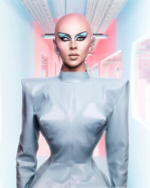 Vespi Instagram - 👽 CHAUVEMENT BELLE 👽
——
Tenue @anethablack / @monsieurmax_ 
Photo et retouche @thefrenchbeautyboy @cyrilpulizzi.photographe 
Création 3D @cwcn_design 
Pose faux crâne @thomykmakeup 
Matière @nona_source 
Lentilles @ttd_eye 
Boucle d’oreille par moi 

——-
Pour ce défilé j’ai travaillé avec @anethablack sur le concept d’une combinaison auto-suffisante dans un futur où l’eau et l’air ne serait pas accessible à tous.tes et que chaque être humain aurais besoin d’avoir sur lui son propre air et sa propre eau pour subsister. 

Cette robe aux lignes extrêmes et géométriques en jersey enduit protège donc la peau, contient des poches d’eau dans les hanches, un casque pour l’oxygène et donne une silhouette i-conique parce que même dans le futur on veut être snatched ! 

Évidemment référence à Barbie dans la colorimétrie et pour pousser le concept futuriste encore plus loin Chad et Cyril on travaillés avec @cwcn_design pour créer entièrement un décor à l’aide de logiciels 3D.

Merci encore à @thomykmakeup 
Pour la pose du faux crâne 🥺
——-

#dragrace #dragracefrance  #rupaulsdragrace #teamvespi #teamvespiche #vespi #drag #dragqueen #rpdr
