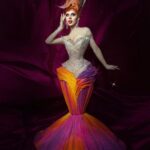 Vespi Instagram - DRAGNIFIQUE 🧡🩷💜 Dress and hair @anethablack Picture @atelier_flipeau & @thefrenchbeautyboy —- Et voici mon dernier look pour @dragrace 🥲 aka la robe parapluie aka l’égérie @instagram Pour cette dernière tenue j’ai décidé que le confort était pour les laides et donc de partir sur une robe rigide, ultra cintrée à la taille et aux chevilles, très lourde,… mais incroyable non ? @anethablack est simplement une magicienne pour avoir réussis à créer cette sublimissime pièce et la perruque qui va avec 😮‍💨🤌🏻 @thefrenchbeautyboy et @atelier_flipeau on collaborés pour réaliser ces superbes photos dont je suis très très fan 😍 Voilà, une page ce tourne mais demain commence la tournée @dragrace_francelive et je n’ai que HÂTE de partager ça avec vous 🥺🫶 #dragrace #dragracefrance #rupaulsdragrace #teamvespi #teamvespiche #vespi #drag #dragqueen #rpdr Paris, France