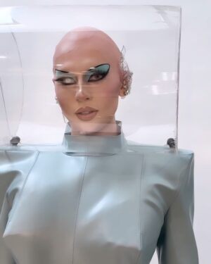 Vespi Instagram - 🤖💎 FUTURISTIC CHIC 💎🤖
——
Tenue @anethablack / @monsieurmax_ 
Photo et retouche @thefrenchbeautyboy @cyrilpulizzi.photographe 
Création 3D @cwcn_design 
Pose faux crâne @thomykmakeup 
Matière @nona_source 
Casque par @capu_dmlhn 
Boucle d’oreille par moi 

——-
Pour ce défilé j’ai travaillé avec @anethablack sur le concept d’une combinaison auto-suffisante dans un futur où l’eau et l’air ne serait pas accessible à tous.tes et que chaque être humain aurais besoin d’avoir sur lui son propre air et sa propre eau pour subsister. 

Cette robe aux lignes extrêmes et géométriques en jersey enduit protège donc la peau, contient des poches d’eau dans les hanches, un casque pour l’oxygène et donne une silhouette i-conique parce que même dans le futur on veut être snatched ! 

Évidemment référence à Barbie dans la colorimétrie et pour pousser le concept futuriste encore plus loin Chad et Cyril on travaillés avec @cwcn_design pour créer entièrement un décor à l’aide de logiciels 3D.

Merci encore à @thomykmakeup pour l’installation du faux crâne ! 

——- For this runway I worked with @anethablack on the concept of a self-sufficient wetsuit in a future where water and air would not be accessible to all and that every human being would need to have on hand. him his own air and his own water to subsist. 

This dress with extreme and geometric lines in coated jersey therefore protects the skin, contains pockets of water in the hips, a helmet for oxygen and gives an i-conical silhouette because even in the future we want to be snatched! 
Obviously a reference to Barbie in the colorimetry and to push the futuristic concept even further Chad and Cyril worked with @cwcn_design to create a set entirely using 3D software. 
Thanks again to @thomykmakeup for the installation of the fake skull!

——

#dragrace #dragracefrance  #rupaulsdragrace #teamvespi #teamvespiche #vespi #drag #dragqueen #rpdr