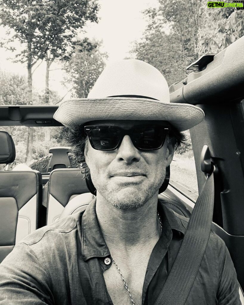 Walton Goggins Instagram - See that smile… I feel like I ate the canary. Just drove back from NYC. Got caught in a rainstorm. Pulled under a bridge. Left when it abated then drove straight into a bigger storm only this time there was no bridge. I got soaked, The car got soaked… everything got soaked. Listening to John Lennon the whole time. Didn’t even have to use a rag… the wind dried it. Now I’m on my dirt road. What a day this has been. Summer Upstate. Every day is something different. Gratitude I tell ya.