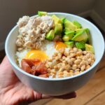 Yumi Stynes Instagram - One of the things we talk about in our cookbook THE FOOD FIX @5minutefoodfix is how to cook perfect rice and what to do with the leftovers!  In my house, (as it is in my mother's house), rice is cooked daily. 🍚 Once in a while - like today, I have leftovers and this is what I did with them: Decanted leftover rice into a ceramic bowl and made two indentations for 2 raw eggs. Gently heated the egg rice combo in the microwave. 1.5 - 2 mins - not long! Topped with avocado 🥑, tuna, umeboshi and nattoo. Ate with Nori using chopsticks. Aaaaaah. Sigh of happiness 😊