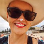 Yumi Stynes Instagram - No one ever takes photos of me. Today at the beach I kissed my kid right after I'd put zinc on her face. "Do I look funny?" I said. "Let me take a photo of you," she said.