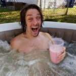 Zach Anner Instagram – My electric razor died in the middle of shaving so I decided to have a strawberry milkshake in the hot tub. Can anyone beat this Saturday? #Milkshake #Hottub # halfbeard #LiveYourBestLife