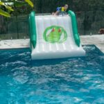 Abby Coleman Instagram - The boys were not impressed with Hubbys building skills when he built our house but blown away when he dug a hole and built the pool and this is where we spend our days. @crocpad this slide is seriously the best and the strongest! Been looking for ages for one that lasts and one we can all use….. big kids and all #pool #poolslide #summer #gift