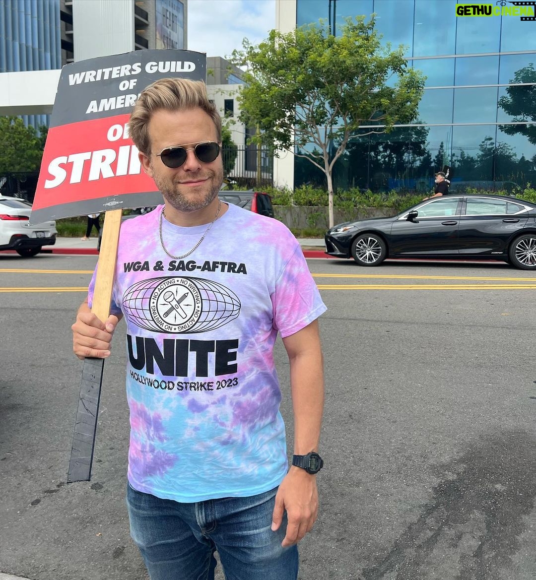 Adam Conover Instagram - RESTOCK!! 100% of the proceeds from these 🌈TIE-DYE🎨 strike shirts benefit @alifeinthearts, and will go to support workers affected by the strike!! The last batch sold out in hours and raised $6000!! This is LAST run we’re doing. Designed by @_ericoverton_ and HAND-PRINTED by my favorite LGBTQ-owned screenprinter, @transfigureprintco. Tap to buy, and brighten up the picket line and support entertainment workers!! Netflix