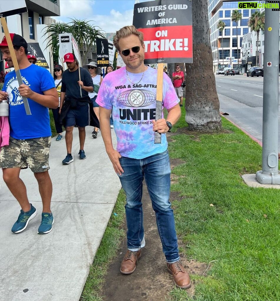 Adam Conover Instagram - RESTOCK!! 100% of the proceeds from these 🌈TIE-DYE🎨 strike shirts benefit @alifeinthearts, and will go to support workers affected by the strike!! The last batch sold out in hours and raised $6000!! This is LAST run we’re doing. Designed by @_ericoverton_ and HAND-PRINTED by my favorite LGBTQ-owned screenprinter, @transfigureprintco. Tap to buy, and brighten up the picket line and support entertainment workers!! Netflix