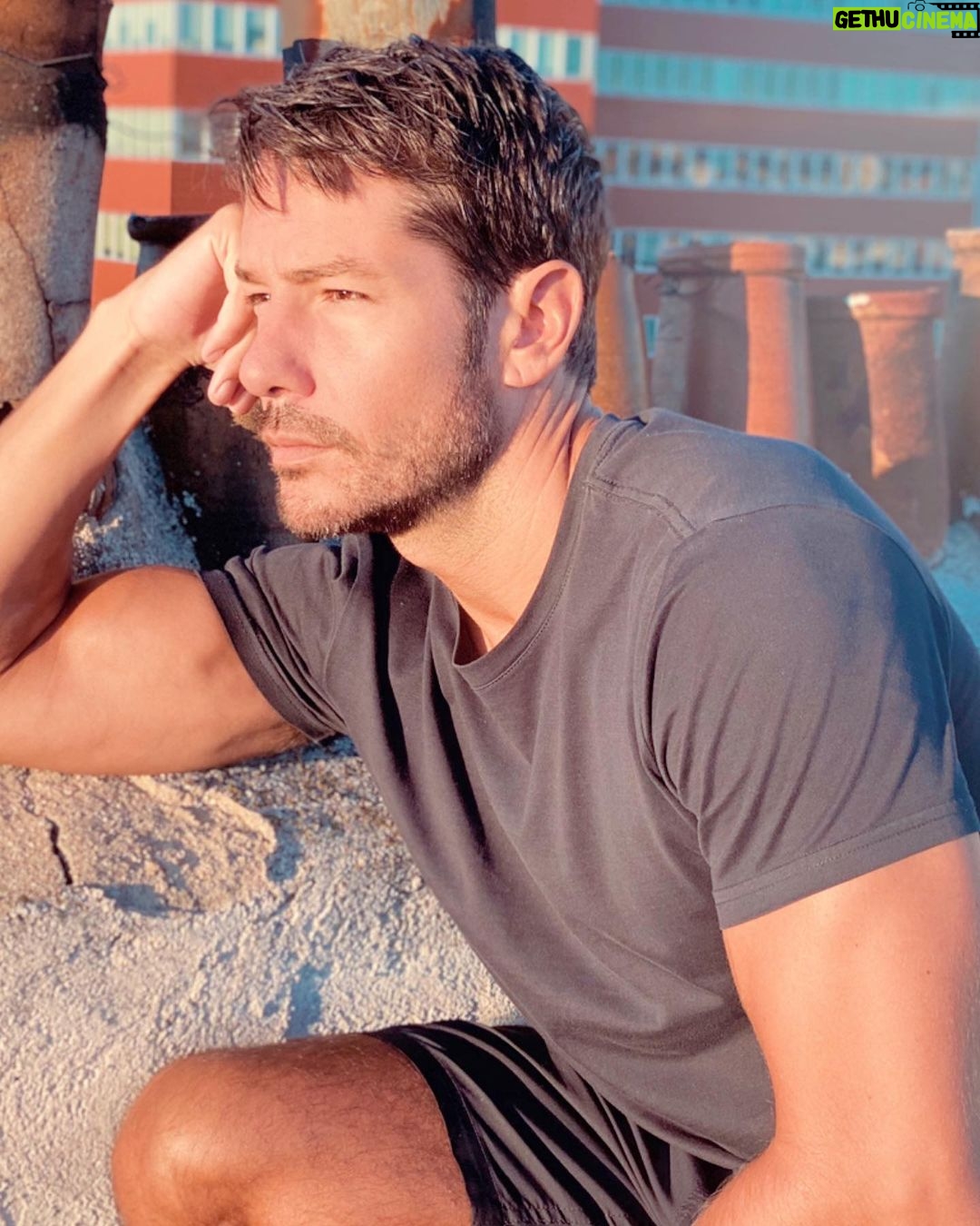 Alejandro Albarracín Instagram - Ayer hice café, hacía mucho tiempo que dejé de beberlo, pero me gusta como huele y no me pude resistir. Me lo bebí, claro, ya que estaba. Así que por la noche he dado mil vueltas en la cama, no he dormido muy bien que digamos. Hoy me he despertado pronto y estaba amaneciendo. Decidí subirme a la azotea a verlo. Lo observé. Grabé un vídeo, el que he puesto en los stories, y pensé que hacía buena luz para hacerme una foto con cara de dormido. 🤷🏻♂️