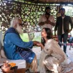 Amy Jackson Instagram - Privileged moment in Coimbatore with @sadhguru - one of the most inspiring visionaries of our time. In between our movie promotions for Mission, we had the opportunity to visit Isha Yoga and meet with the creator himself and learned about his own mission concerning holistic well-being and sustainable causes - all of which is having a hugely positive impact on the world we live in. Whilst spending time with Sadhguru, we discussed all sorts of subjects from raising HAPPY, healthy children, to the world’s future mental health crisis and the importance of creating an environment that fosters wellbeing for ourselves. Mindful eating was a big talking point and having the connection between the food we consume and the health of the soil it comes from - which is currently in a deeply concerning state and why Sadhguru went on a 100 day ‘motorcycle mission’ to save soil! So, thank you Sadhguru your transformative teachings and support for noble initiatives make a profound difference in the world. It was such an honour spending time with you and your volunteers ✨ I can't wait to visit again soon. Also, so much love to @anitadongre for the stunning Salwar I wore for the occasion. Anita continuously promotes traditional crafts and artisans, and advocates for responsible fashion. I love her designs 💘 Swipe to the end for a giggle!!!