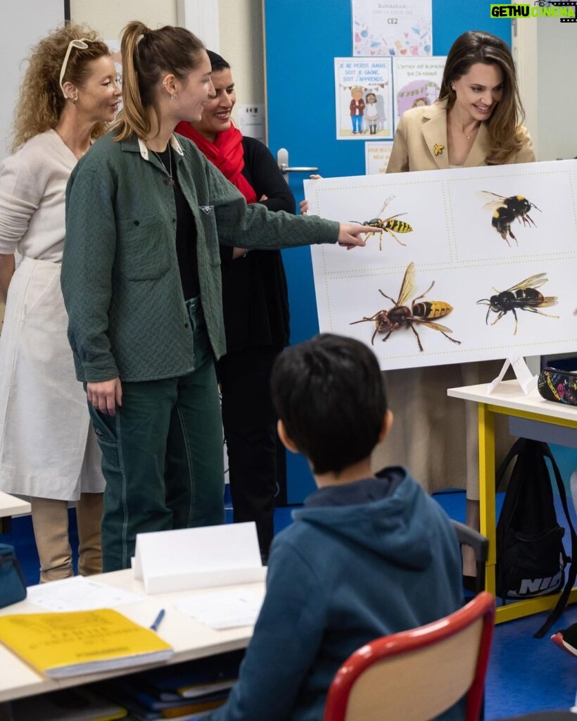 Angelina Jolie Instagram - I had the pleasure of participating in a Bee School a few weeks ago at a primary school in Clichy-sous-Bois, France, to teach the kids the key role bees play as pollinators to our food safety and in biodiversity conservation. The class was lovely. Brilliant young minds asking great questions. Children always understand quickly what adults often try to overcomplicate or excuse. There were many smiles except when they realized that without bees there was no chocolate! We discussed how the disappearance of bees is a worldwide phenomenon which is endangering biodiversity. These are the kinds of committed daily actions you can do with your kids at home: 1. Plant ‘melliferous’ - pollen and nectar-rich plants - to create a safe habitat and substantial food source for bees. 2. Set up your own bee waterer at home. Bees need water, not only to quench their thirst, but also to nurse developing larvae and keep their nests cool during summer. This is how you can create a safe bee waterer at home: * Grab a large bowl, not made of plastic or aluminum. It is important that the materials are porous or mineral, so that the bees can have a better grip and avoid drowning. Such materials let water fill in the little gaps more easily, allowing bees to drink. * Add water and rocks, stones and/or pebbles. Corks can also be a good alternative. * Place the waterer in your garden. Bees must be able to access it easily, so it should be left out in the open, in a large enough area that is free of any safety hazards. @Guerlain #GuerlainBeeSchool #GuerlainforBees Photography by Ian Gavan More information about the bees can be found in the Assessment Report on Pollinators, Pollination and Food production by IPBES. Link in my bio.