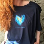 Anna Ador Instagram - we created this T-shirt in support of creative people and artists who are currently out of jobs. The only way they can continue earning is by selling their work. And I strongly encourage you to be that help for them. All the money raised from the selling of the t-shirts will go to my sister and her creative community. Let's support their independent brand and make a little difference. Follow the link in bio 📍 Thank you @helenakazakevich @veterra 💙💛