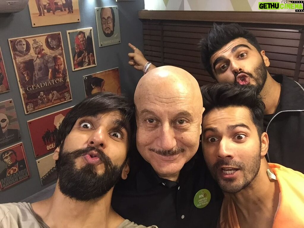 Anupam Kher Instagram - Caption this pic: I don’t know why this pic of #Ranveer #Varun and #Arjun taken few years back reminds me of the film #Padosan. May be the madness created here. Also don’t miss #Arjun ponting to the poster of #DrDang from the movie #Karma! 😂😂🤣🤣❤️ #ActorsLife #Friends #Fun Taj Dubai Hotel