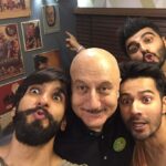 Anupam Kher Instagram - Caption this pic: I don’t know why this pic of #Ranveer #Varun and #Arjun taken few years back reminds me of the film #Padosan. May be the madness created here. Also don’t miss #Arjun ponting to the poster of #DrDang from the movie #Karma! 😂😂🤣🤣❤️ #ActorsLife #Friends #Fun Taj Dubai Hotel
