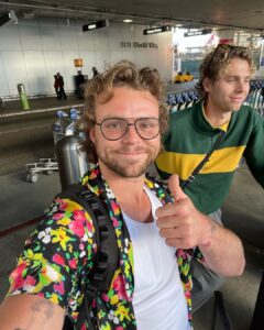 Ashton Irwin Instagram - 28, brushing up on my essential Buddhism , starting to wear the cowboy hat seriously, returning to the social security of a leather jacket & pressure washing at a pretty serious level now. And the last one with the thumbs up at LAX, is a guy who’s just hoping he didn’t get Covid in the airport, ciao!
