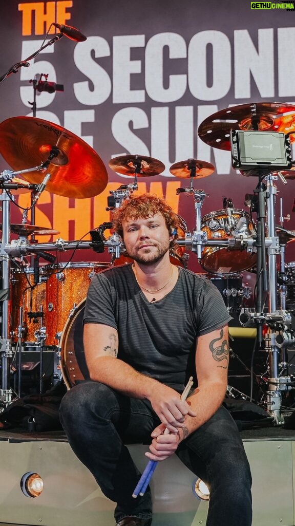 Ashton Irwin Instagram - Watch Ashton Irwin breaking down some of his favorite 5SOS drum parts! 👊🏼 From conceptualizing the live shows and crafting merchandise, Ashton explains how the band members’ involvement goes beyond playing their instruments. But what truly sets him apart is his incredible ability to sing while drumming, a feat that’s not just about musical talent but also demands exceptional independence, fitness, and a unique focus on vocal support. 🎤 Click the link in our bio to watch the full #DrumeoBackstage interview where he talks about his early inspiration for playing the drums and how he got started at a young age, drawing inspiration from bands like The Police and Led Zeppelin. 🎬 @ashtonirwin @5sos #5SOS #5SecondsOfSummer #5SOSFam #5SOSFamily #5SOSFans #AshtonIrwin #5SOSDrummer #Drumeo #DrumLife #Drummer #Drumming #DrummingPassion #LukeHemmings #CalumHood #MichaelClifford #Youngblood #5SOSMusic #5SOSLyrics #5SOSConcert #5SOSLive #5SOSMerch #5SOSUpdates #5SOSAlbum #5SOSArt #5SOSFandom #5SOSInfection #5SOSHeartbreak #5SOSTour #5SOSPhotography Budweiser Stage