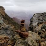 Azim Rizk Instagram - On the edge of a cliff the view is grand and terrifying; our struggle to climb a little higher in life is put in #perspective by this tiny stack of rocks staring out at the #grandcanyon; they have the same view of the wonder of this planet and the same fear of leaning a little too close and falling; and though the bottom rock is feeling the most weight on its shoulders as it faces the oblivion, it's the top rock who's truly terrified to fall. I'm happy to be in the stack with all of you