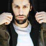 Azim Rizk Instagram - This is how I dramatically put on a hood. How’d I do? 😂 Shout out to the talented @kep.exe who makes me look badass no matter what I do! . . . . . . . . . . . #photography #bestphotographer #sweatshirt #sodramatic #mensfashion #middleeastern #iwanttoworkwith @missionworkshop #dudesinhoodies #curlyhair #menwithbeards #deathstare #intense