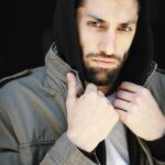 Azim Rizk Instagram - This is how I dramatically put on a hood. How’d I do? 😂 Shout out to the talented @kep.exe who makes me look badass no matter what I do! . . . . . . . . . . . #photography #bestphotographer #sweatshirt #sodramatic #mensfashion #middleeastern #iwanttoworkwith @missionworkshop #dudesinhoodies #curlyhair #menwithbeards #deathstare #intense