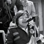 Barack Obama Instagram - Judy Heumann dedicated her life to the fight for civil rights—starting as a young organizer at Camp Jened and later helping lead the disability rights movement. Michelle and I were fortunate to work with Judy over the years, and are thinking of her family and friends. [Image description: A black and white photo of Judy Heumann. In the photo, she has short, chin-length hair and octagon-shaped metal glasses and is speaking into a microphone while seated in a manual push wheelchair. She is wearing a coat with a large button pin with words that read “SIGN 504” in very large block letters and “HUMAN RIGHTS ACCD” in smaller block letters.]