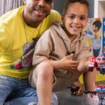 Bradley Mcintosh Instagram - “#AD Did you know, almost 1/5 of us put down our childhood toys for the last time when we’re 5 years old? You all know me as a big kid at heart, but as I’ve found out from working with Hasbro to launch its new Transformers range of toys, 77% of us miss out on play time and the fun to be had with toys because of work, chores, song writing…   Me and my son Kairo got the chance to work together on our first major project – where I was given the space and time to introduce him to my childhood favourite toy – Transformers – we had the most amazing time playing with the brand-new range that he can now hold memories of forever. It’s now his favourite toy, too! Hasn’t left his side since it got here. You can also unlock the joy of play now and throw yourself back to those 90’s memories with your transformers toys by heading to Smyths or the Entertainer #Transformers @transformersofficial @hasbro”
