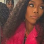 Brandy Norwood Instagram - Cam @mr_camron - you still ain’t explain to me what computer is Putin means. Matter fact, just tell me what is Putin? And it’s August fam- this coat is very unnecessary 💕 #gettemgirl #Crown 📸 @nikkrokkshair