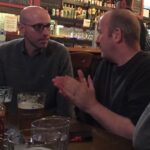 Brian K. Vaughan Instagram – Tomorrow! All generous paid subscribers to Exploding Giraffe will be able to listen in LIVE as I nervously record the debut episode of my new podcast-thing MATURE READERS with my favorite writer in comics (presuming Alan Moore is really retired), GARTH ENNIS, seen here belittling me for ordering a hazy IPA, probably. It’s all happening this Friday at 2pm Pacific/5pm Eastern. I realize that hour will be the middle of the workday for some of you employed-types, but come on, all of your colleagues are just watching March Madness anyway, so shut your (home) office door, grab an Anchor Steam or other Ennis-approved libation, and join us for an hour of hopefully not-too-awkward chitchat about comics, violence, sex, and Garth’s tireless defense of ALIEN 3. If you can’t make it, these two Luddites will do our best to record the talk, but that will also only be available to members of The Tower (not a pyramid scheme, just what you call a bunch of giraffes), so if you haven’t become a paid subscriber yet, there’s still plenty of time to join our pack (link in bio) before I send out the private link tomorrow. Thanks for listening, and for supporting the completion of SPECTATORS, my new graphic novel with @niko_henrichon. You’re the best. #garthennis #bkv #beer