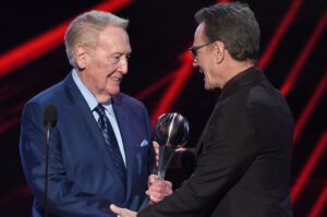 Bryan Cranston Instagram - A part of my childhood died yesterday. That may sound dramatic, and maybe it is, but it is how I’m feeling today. Los Angeles Dodgers’ legendary announcer, Vin Scully passed away at 94. What a brilliant life he led, and what an important part of my life he served. From the time I was able to understand what the radio was I would listen to Dodger baseball games. It was the beginning of a lifelong joy. Vin was never just about the score of the game. His stories made you feel like you were with him… like he was sharing a story just for you. As a child that was often a bedtime story, as I’d hide my transistor radio under my pillow to avoid parental detection. When times were tough, Vin was there to ease my pain or insecurities with the power of distraction. Because even if it was for only the next three hours, listening to Vin’s voice made me feel safe. Comforted. One of my greatest thrills was introducing Vin to my daughter, Taylor, at the ESPY’S in 2017, after I had presented Vin with the Icon Award. Taylor, an adult, and a catcher in her little league experience, nervously confessed to Vin that she listened to him her whole life… just like her dad.
His signature opening statement is indelible in my memory, “Hi everybody, and a very pleasant good evening to you, wherever you may be.” I’m here, Vin…I’m right here.
