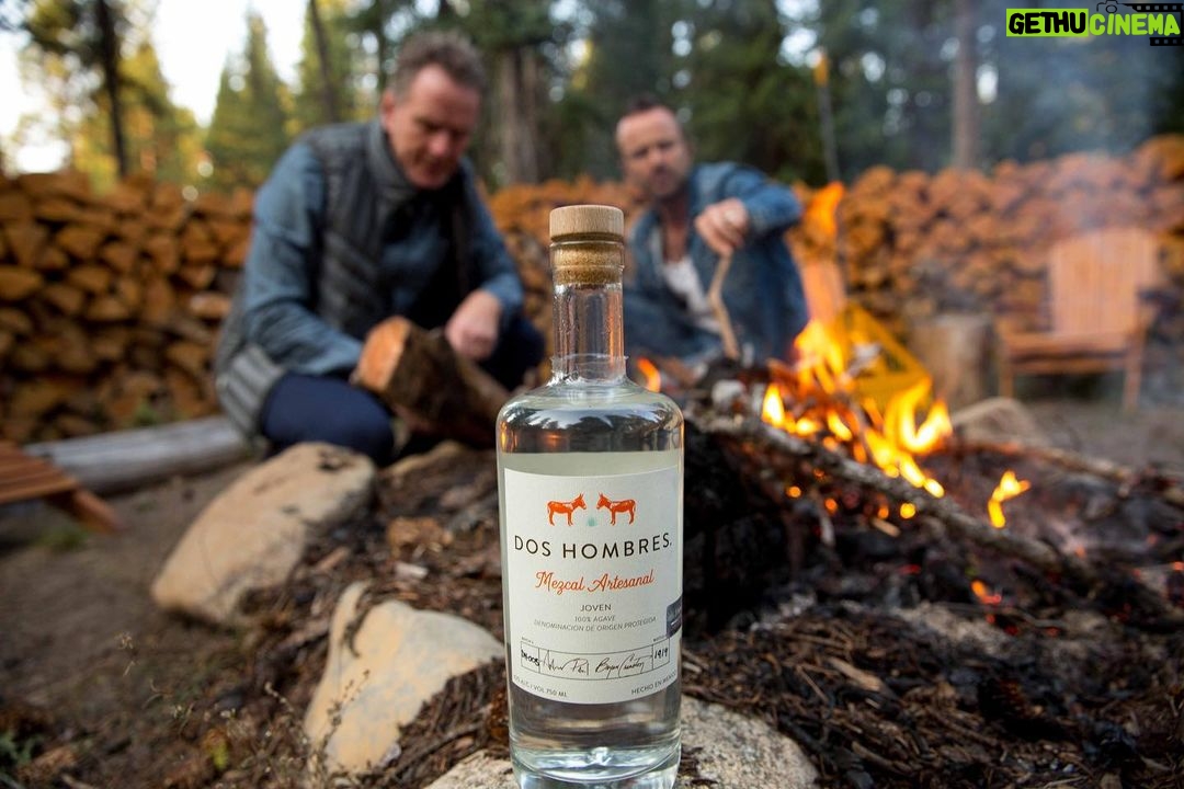 Bryan Cranston Instagram - Just a couple of guys wearing denim, sitting around a fire and drinking the finest Mezcal out there. Cheers everyone. 🥃