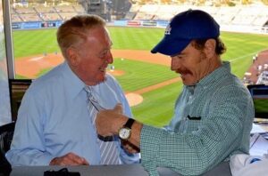 Bryan Cranston Instagram - A part of my childhood died yesterday. That may sound dramatic, and maybe it is, but it is how I’m feeling today. Los Angeles Dodgers’ legendary announcer, Vin Scully passed away at 94. What a brilliant life he led, and what an important part of my life he served. From the time I was able to understand what the radio was I would listen to Dodger baseball games. It was the beginning of a lifelong joy. Vin was never just about the score of the game. His stories made you feel like you were with him… like he was sharing a story just for you. As a child that was often a bedtime story, as I’d hide my transistor radio under my pillow to avoid parental detection. When times were tough, Vin was there to ease my pain or insecurities with the power of distraction. Because even if it was for only the next three hours, listening to Vin’s voice made me feel safe. Comforted. One of my greatest thrills was introducing Vin to my daughter, Taylor, at the ESPY’S in 2017, after I had presented Vin with the Icon Award. Taylor, an adult, and a catcher in her little league experience, nervously confessed to Vin that she listened to him her whole life… just like her dad.
His signature opening statement is indelible in my memory, “Hi everybody, and a very pleasant good evening to you, wherever you may be.” I’m here, Vin…I’m right here.