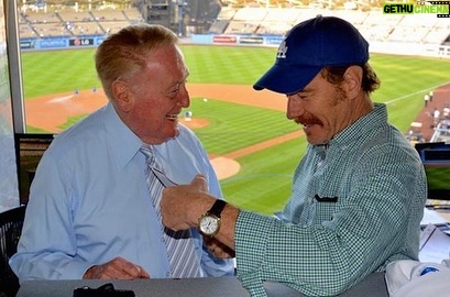 Bryan Cranston Instagram - A part of my childhood died yesterday. That may sound dramatic, and maybe it is, but it is how I’m feeling today. Los Angeles Dodgers’ legendary announcer, Vin Scully passed away at 94. What a brilliant life he led, and what an important part of my life he served. From the time I was able to understand what the radio was I would listen to Dodger baseball games. It was the beginning of a lifelong joy. Vin was never just about the score of the game. His stories made you feel like you were with him… like he was sharing a story just for you. As a child that was often a bedtime story, as I’d hide my transistor radio under my pillow to avoid parental detection. When times were tough, Vin was there to ease my pain or insecurities with the power of distraction. Because even if it was for only the next three hours, listening to Vin’s voice made me feel safe. Comforted. One of my greatest thrills was introducing Vin to my daughter, Taylor, at the ESPY’S in 2017, after I had presented Vin with the Icon Award. Taylor, an adult, and a catcher in her little league experience, nervously confessed to Vin that she listened to him her whole life… just like her dad. His signature opening statement is indelible in my memory, “Hi everybody, and a very pleasant good evening to you, wherever you may be.” I’m here, Vin…I’m right here.