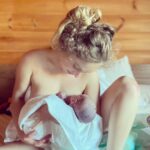 Carson Meyer Instagram - Part 4 of 4: Our Birth Story After a couple hours in the tub, the water was no longer serving me and I wanted OUT. I crawled into bed and draped myself over Johnathan’s shoulders. For the next hour my body moved instinctively to make way for Lou. I got onto all fours with my right leg bent up by my right hand. Johnathan placed his hands below her emerging head ready to catch. (I made him watch a million @indiebirth birth videos in pregnancy). Once her head was out, she took her first breath and cleared her lungs with a cry. With the next wave she emerged into her father’s hands and was passed under my legs up to me. She was born at 3:50pm. Although we waited to find out, I had a strong feeling she was a girl my entire pregnancy (I even filled her closet with my childhood dresses). “It’s her!”, we said laughing. I knew all along! Paulie, who had been under the bed, popped up in celebration, doing laps around the room. Just like our labor, the sacred moments following her birth were completely undisturbed. We let the physiological process unfold as we had through pregnancy and labor. The bliss I had been waiting for arrived and we were soaring with oxytocin. Nobody violently “stimulated” her, suctioned her or touched her at all besides the two of us. Nobody “massaged” my uterus, nobody cut her cord or tugged at the placenta. These were things I’ve seen done unnecessarily and without consent far too often and it broke my heart every time. After an hour of cuddling, Johnathan cut the cord. I still had to birth the placenta and I was nervous. This was the final stage of birth that needed to happen safely. My midwife intuited that I was on edge about it and resisting any support in guiding it out. She asked if I wanted to squat in the shower to birth my placenta alone. She placed a bowl between my legs and I spoke to the placenta, thanking it for taking such good care of Lou, for being the source of her nourishment and protection. I told my placenta that its work was done and I guided it out with ease. We fell asleep in each other’s arms just as the sun set over the Blue Ridge Mountains.