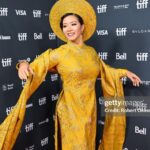 Chantal Thuy Instagram – This week at #TIFF was a dream come true. It’s always been on my bucket list to tell a Vietnamese Québécois story on the big screen and to be part of a film based on such a celebrated novel by @kimthuylythanh fulfilled a deep need as a storyteller. Not only is it the first of its kind for this community, but walking in her mother’s shoes helped me understand my own mom’s journey more deeply. In the process of shooting this film last year, I too became a first time mom.
To add to this, the most magical part of the night besides watching the film with my RU family and best friends, was being dressed in a custom traditional Vietnamese Áo Dài khăn đóng created by @thainguyenatelier. Thai not only made me feel beautiful in this dress (as a 8month postpartum mama, I was nervous about getting back on a red carpet 🤷🏻♀️), but he made me feel pride in representing and celebrating my culture. I’m holding onto everything I can that is a part of my Vietnamese heritage (language, food, customs) and wearing this beautiful Áo Dài khăn đóng certainly is an important part of it.
I’m writing this as my sister union in the US is on strike, and acknowledge that we’re going through an extremely difficult time right now. I’m thankful that SAG-AFTRA allowed me to promote this film (under a UDA contract). I’m proud to have worked on my first Canadian film, which was entirely funded by the Canadian & Quebec government agencies @la.sodec @telefilm_canada @amalga.prod @imminafilms @tiff_net
❤️ Gorgeous hair & makeup by @ivylammakeup Toronto International Film Festival (Tiff)