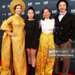 Chantal Thuy Instagram – This week at #TIFF was a dream come true. It’s always been on my bucket list to tell a Vietnamese Québécois story on the big screen and to be part of a film based on such a celebrated novel by @kimthuylythanh fulfilled a deep need as a storyteller. Not only is it the first of its kind for this community, but walking in her mother’s shoes helped me understand my own mom’s journey more deeply. In the process of shooting this film last year, I too became a first time mom.
To add to this, the most magical part of the night besides watching the film with my RU family and best friends, was being dressed in a custom traditional Vietnamese Áo Dài khăn đóng created by @thainguyenatelier. Thai not only made me feel beautiful in this dress (as a 8month postpartum mama, I was nervous about getting back on a red carpet 🤷🏻♀️), but he made me feel pride in representing and celebrating my culture. I’m holding onto everything I can that is a part of my Vietnamese heritage (language, food, customs) and wearing this beautiful Áo Dài khăn đóng certainly is an important part of it.
I’m writing this as my sister union in the US is on strike, and acknowledge that we’re going through an extremely difficult time right now. I’m thankful that SAG-AFTRA allowed me to promote this film (under a UDA contract). I’m proud to have worked on my first Canadian film, which was entirely funded by the Canadian & Quebec government agencies @la.sodec @telefilm_canada @amalga.prod @imminafilms @tiff_net
❤️ Gorgeous hair & makeup by @ivylammakeup Toronto International Film Festival (Tiff)