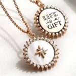 Cherie Jimenez Instagram - So sweet of @origamiowl Think Goodness to feature my beautiful family & honor my Mom @sandydaly68 as a Gigi in the Annual Catalog ✨ Dedicating the Phoenix Charm to the birth of my sweet baby boy Phoenix ❤️‍🔥 My mom has worked for this wonderful company for over 9 years. I have watched her blossom & grow into a force for good. She has touched so many lives & loves what she does. Thank you @chrissyweems & @bellagraceweems for everything that you do for her, for our family ✨ The only Mascara I wear & Most of the jewelry I wear is from her site 🦋🪄Campsite.bio/sandydaly or go to her Instagram & click the link in her Bio • @sandydaly68 ✨