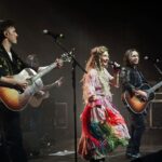 Clare Bowen Instagram - The #NashvilleReunionTour was SO much fun. Do you know which song we’re singing here? It’s one of my faves. 🥰✨ 📷 @christiegoodwin ✨ 👗 @magnoliapearlclothing 🤍 #nashville #london #jonathanjackson #clarebowen #bowenyoung #sampalladio #livemusic #nashvilleabc #nashvillecmt #tambourine #slinginrainbows #brandonrobertyoung #countrymusic #americana #family