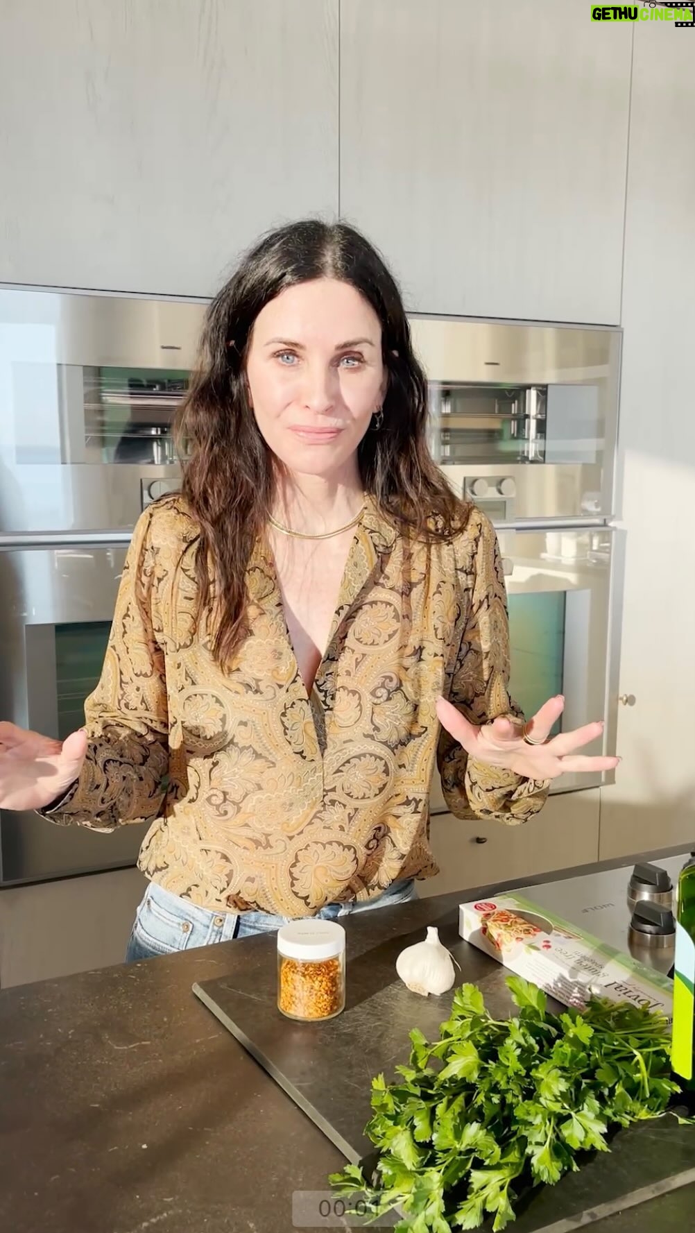 Courteney Cox Instagram - Aglio E Olio Cut up about 5 to 8 cloves of garlic into small chunks. You want the garlic to be big enough to cook and soften in the oil for flavor. Use more if you like. You can never have too much garlic. Wash, dry, and chop a generous portion of Italian Parsley. (I usually do this first so that it’s dry enough to chop when cooking the pasta). Begin boiling the water for pasta. Add a generous amount of salt to the water but no oil. I use gluten free. But you can use any type. Either way make sure it’s a very good pasta, like “Trafilatta en Bronze” or something in Bronze. It’s coarser so the oil will stick to it better. In a large sauce pan add Extra Virgin Olive Oil coating the entire bottom of the pan. Begin to heat the oil adding salt and ground pepper to taste. Put the garlic in the oil. You want the garlic to turn a little golden. Add a chicken bouillon cube JUST BEFORE YOU TAKE THE PASTA OUT OF THE WATER TAKE 3 CUPS OF THE PASTA WATER. Add the water to the oil. This is probably the most crucial part. You want more water in it than you think because the pasta will absorb 85% of it if it’s good pasta. If not maybe only 1.5 cups of pasta water. Mix the oil and water a little then add the pasta. (I LIKE TO COOK THE PASTA ABOUT A MINUTE LESS SO THAT I CAN ADD IT TO THE OIL AND WATER AND CONTINUE COOKING FOR ABOUT A MINUTE) At that point you add the chopped parsley and mix it in. You can add red chili flakes if you like it a little spicy. #courteneycoox