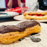 Courtney Ford Instagram - Gluten-free pastries to celebrate our 1st indoor family gathering in over a year and a half🥳 Grateful for: family, vaccines, hugs, music, dancing, and pastries with a side of nachos, (don’t worry about it). Baking shout out to @bobsredmill 1-1 gluten free flour (w/ 3 eggs plus 1 egg white to make choux that was lighter than air ☁️), @meyenberggoatmilk (for the base of the silkiest, most luxurious creme patissiere I’ve ever made- I mean. look. at. IT!- which my family could enjoy w/o digestive issues, and when it came down to choosing between cow or goat dairy pastry cream, they said “f(orget) the cow”😜 cc @taylororci) Sous chef shout out to @roxythegent for piping perfect eclair-sized eclairs, while I piped Murder Durder hoagies, and for filling them like a boss. As my son likes to say: best. day. ever.☀️
