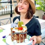 Courtney Ford Instagram - Proof of life. Proof of cake. 🎂: gluten-free chocolate/vanilla swirl cake, w/ german buttercream and strawberries inside, covered with white and dark chocolate “tree bark”, with a toasted mini marshmallow fire pit with strawberry fire 🍓 🔥 Paper cake topper decorations from @bonjourfete ✨
