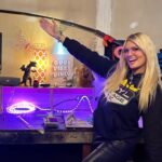 Courtney Hansen Instagram - Mimicking Barbie’s pose. Our camera crew created their space & incorporated my motto. Love it!!! And how badass is Bryan’s design area? This is only a little part of #ROYLGarage #goodvibesonly 💜